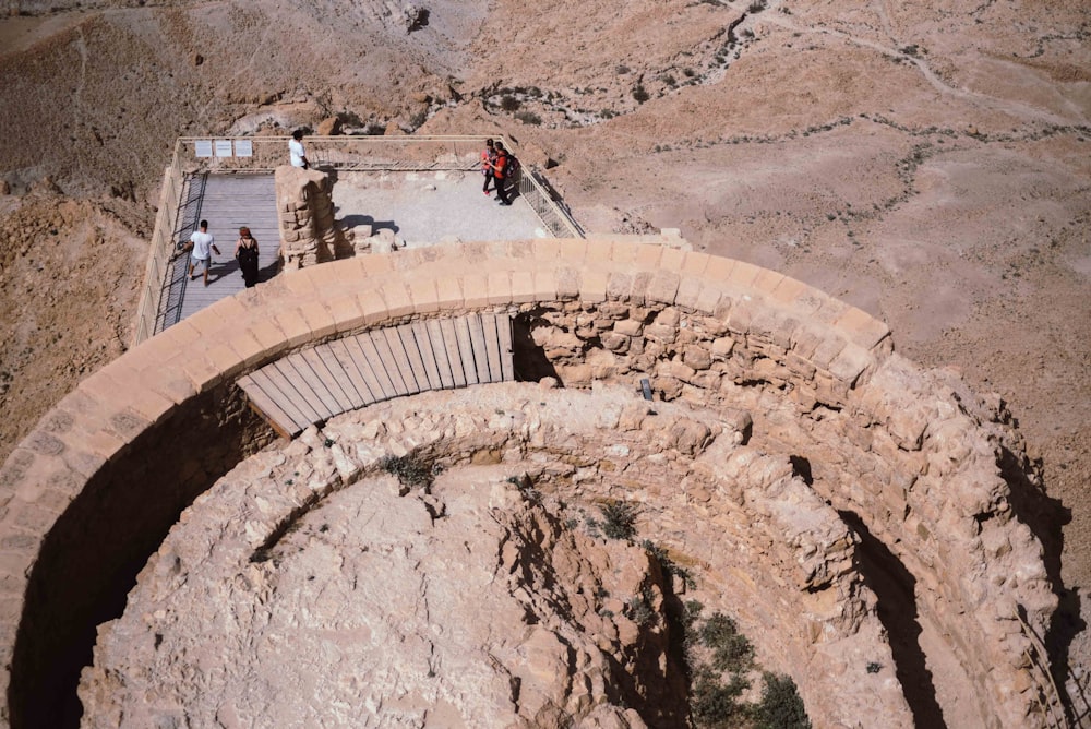 people walking on brown concrete stairs during daytime