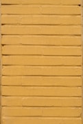 yellow concrete wall during daytime