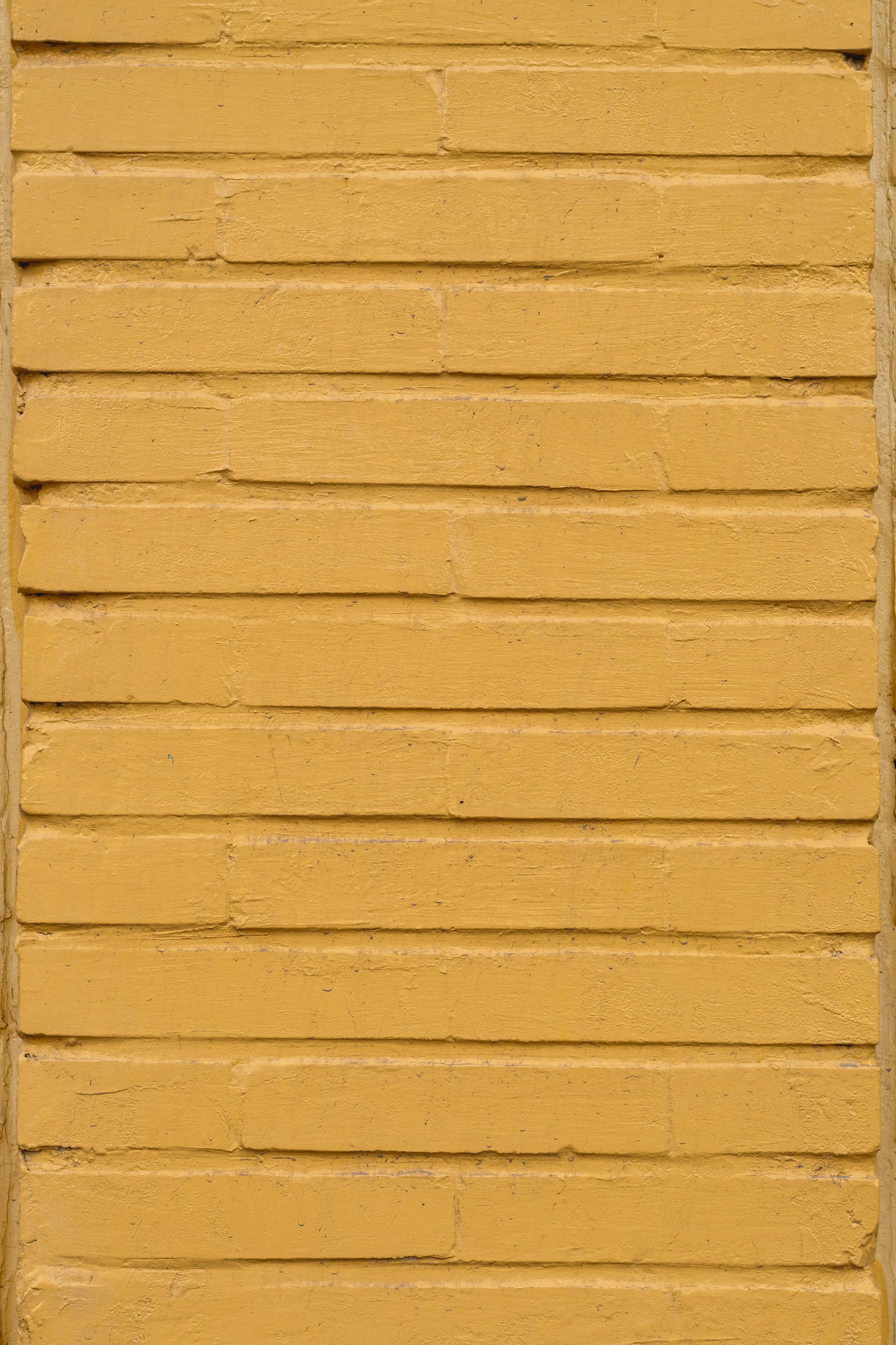 yellow concrete wall during daytime