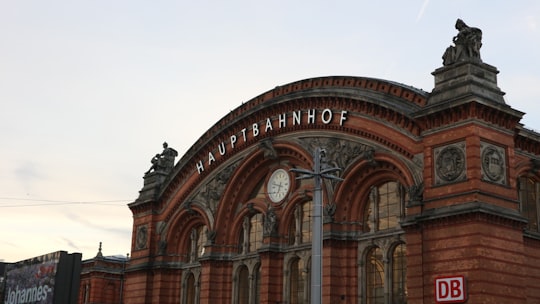 brown concrete building under white sky during daytime in Bremen Hauptbahnhof Germany