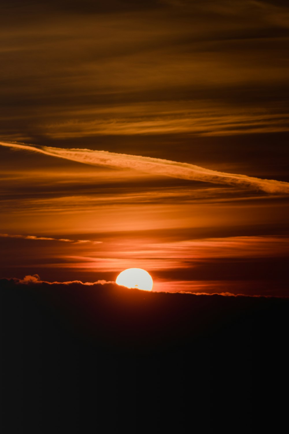 sun setting over the clouds