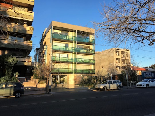 white car parked beside brown building during daytime in Mendoza Argentina