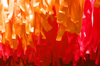 A festive banner design showcasing bright orange and white colors with dynamic shapes.