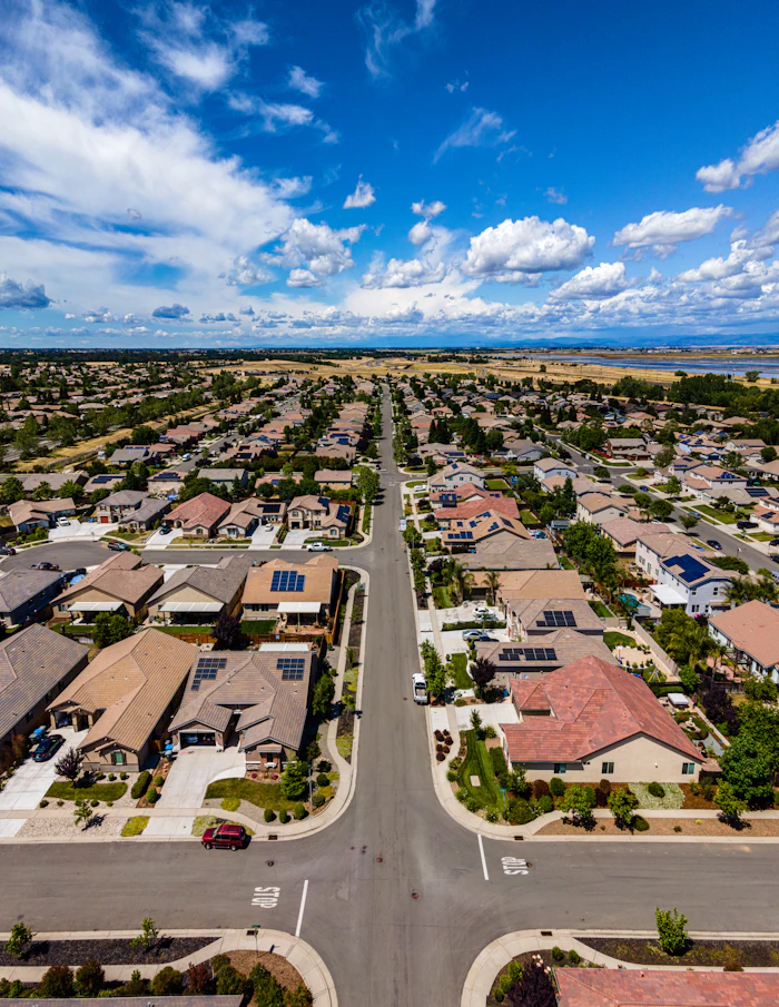 An aerial view of a suburban street of houses