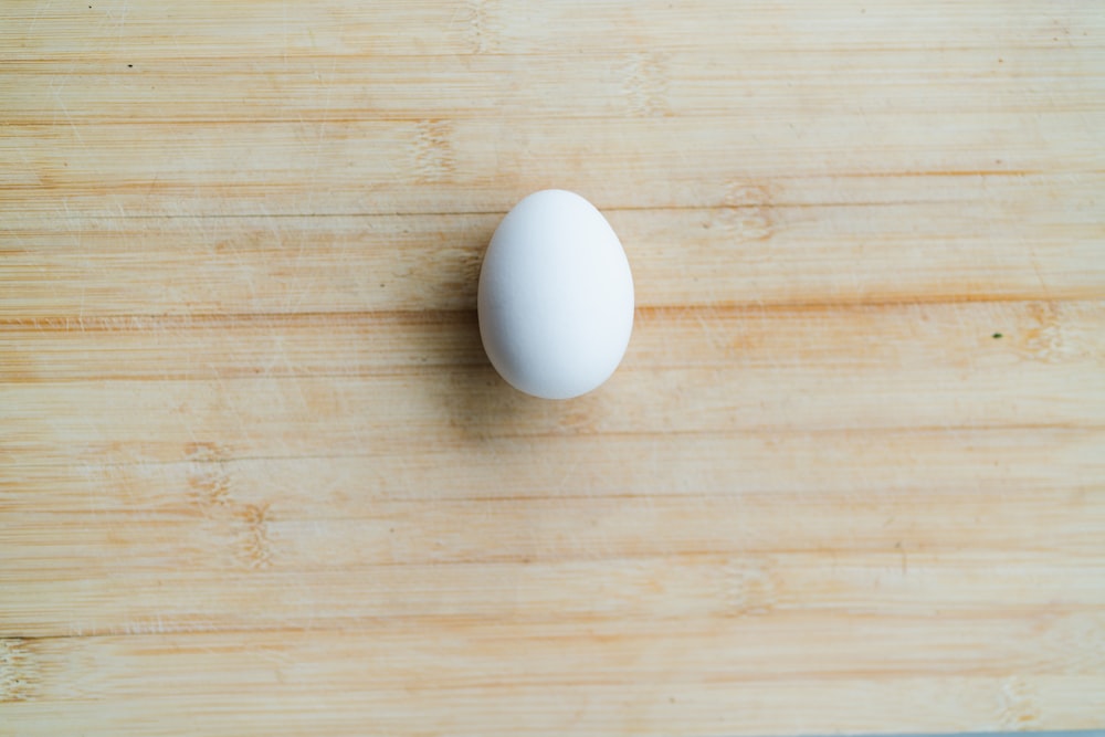 white egg on brown wooden table