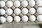 Neatly arranged egg cartons ready for sale in a bright store setting