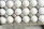 Close-up of hands opening a carton of double-yolk eggs on a wooden table