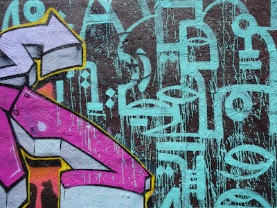 Colorful abstract artwork covering a smooth indoor office wall.