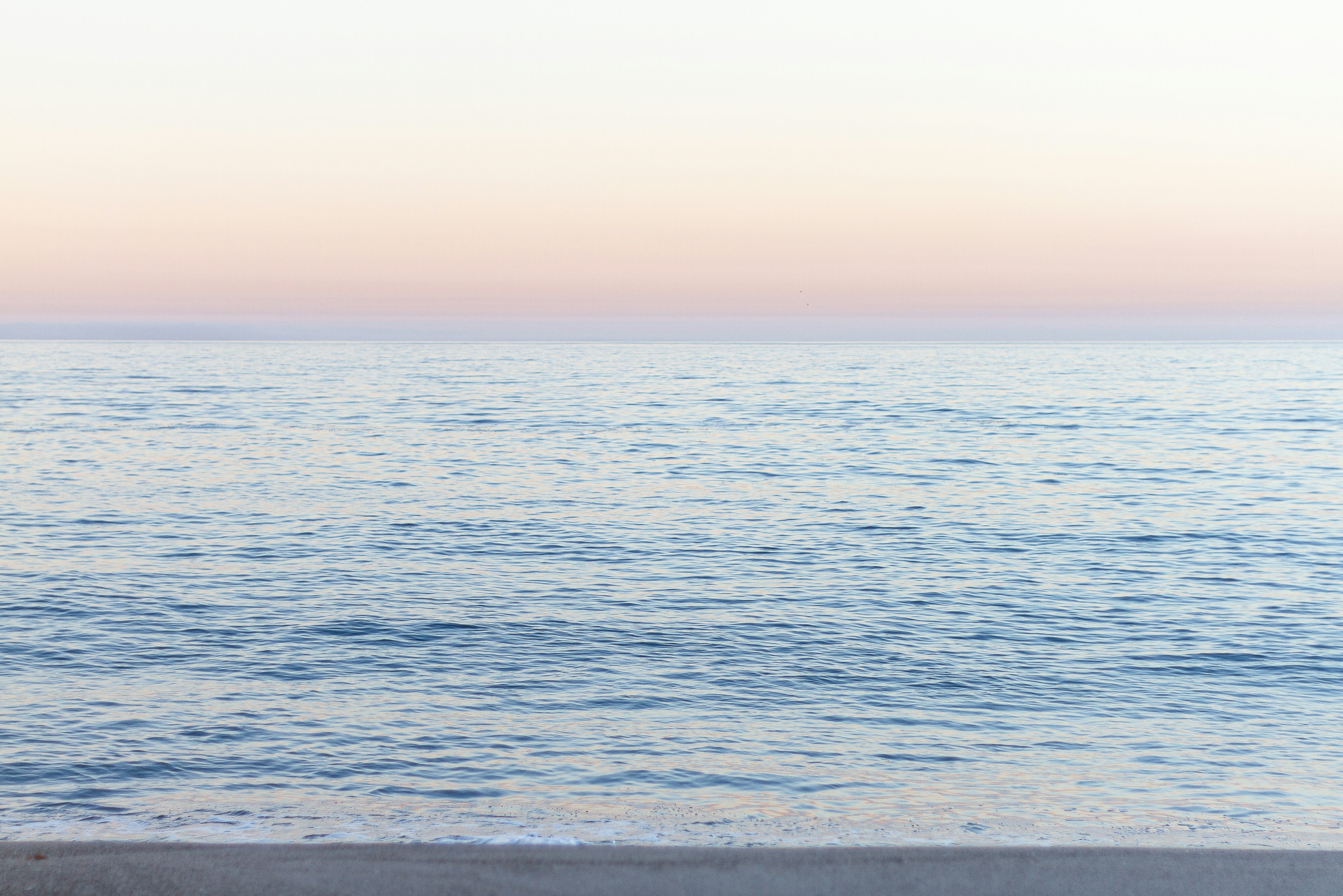 calm sea under blue sky during daytime