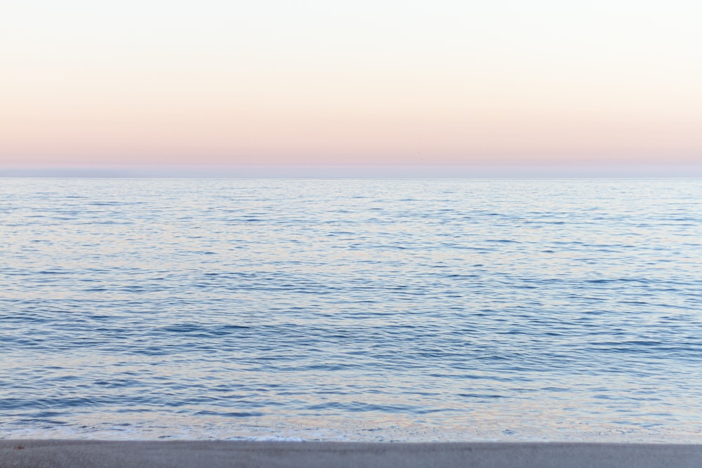 calm sea under blue sky during daytime