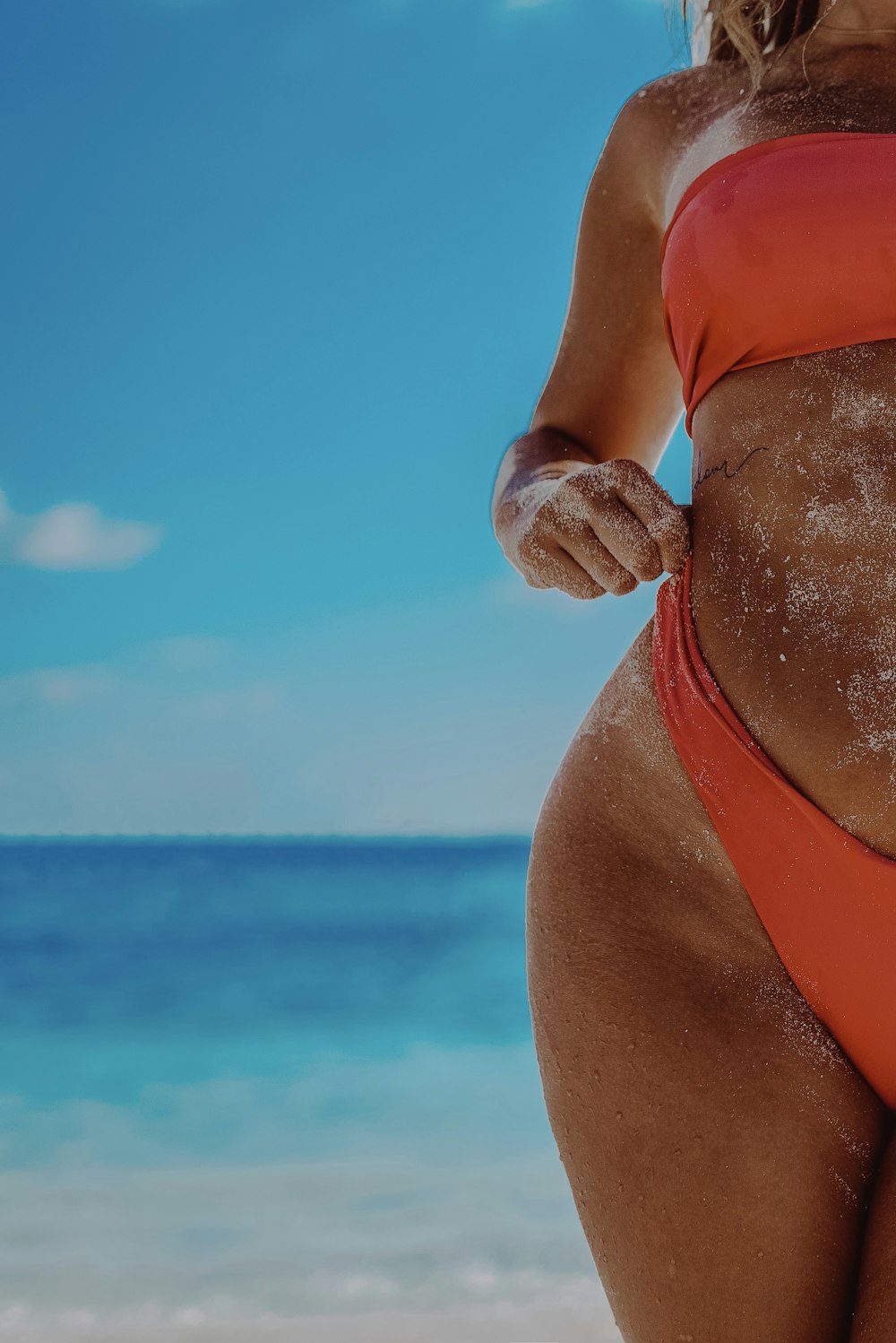 woman in red bikini bottom on beach during daytime