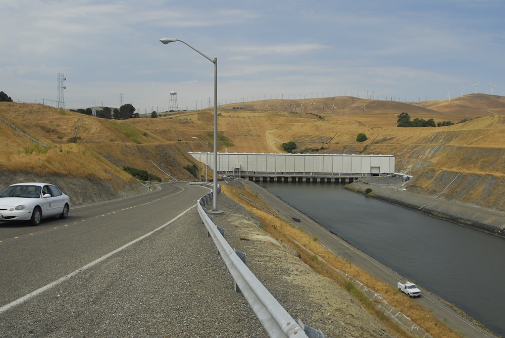 gray concrete road near green grass field during daytime