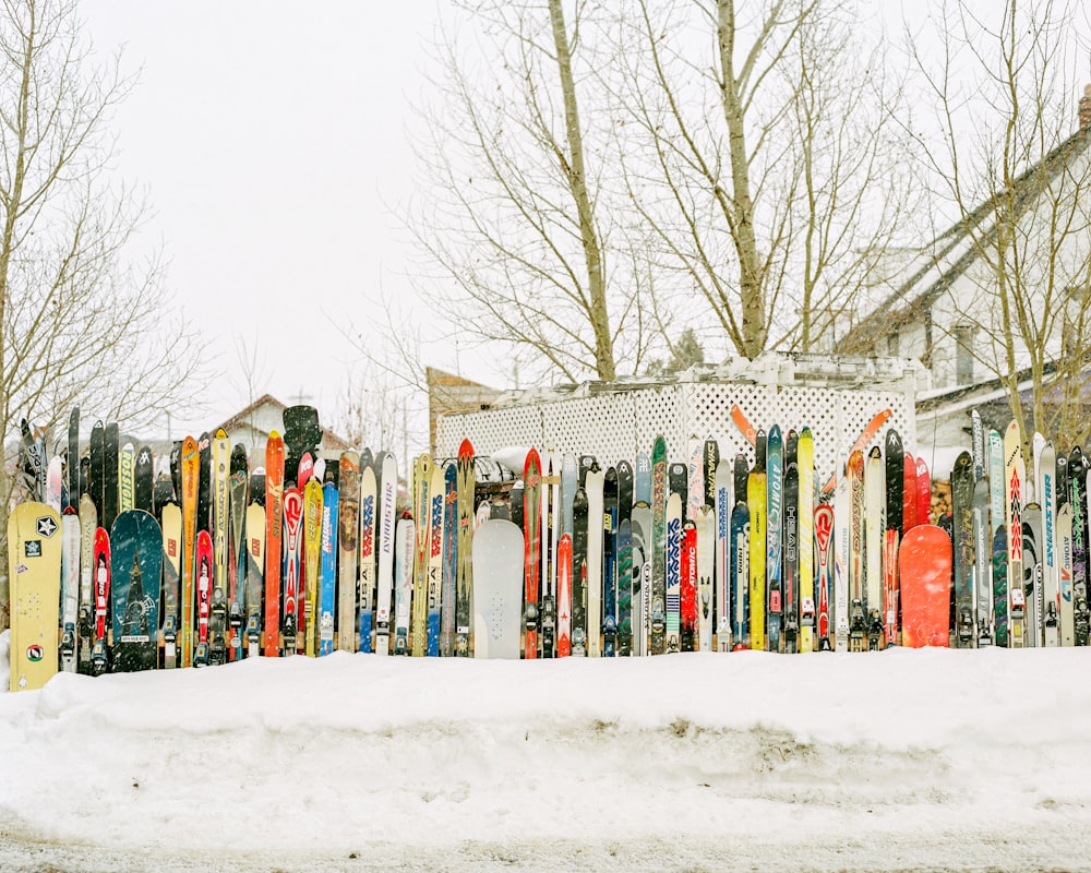 red blue and white wooden fence covered with snow