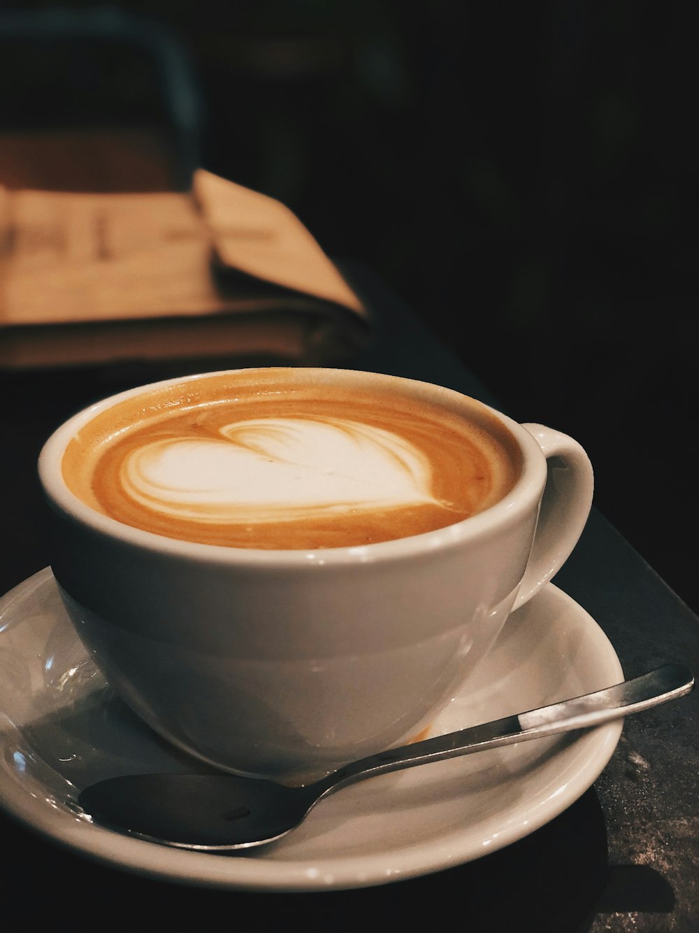 white ceramic cup with brown liquid