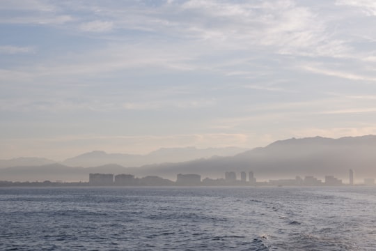 body of water near city buildings during daytime in Puerto Vallarta Mexico