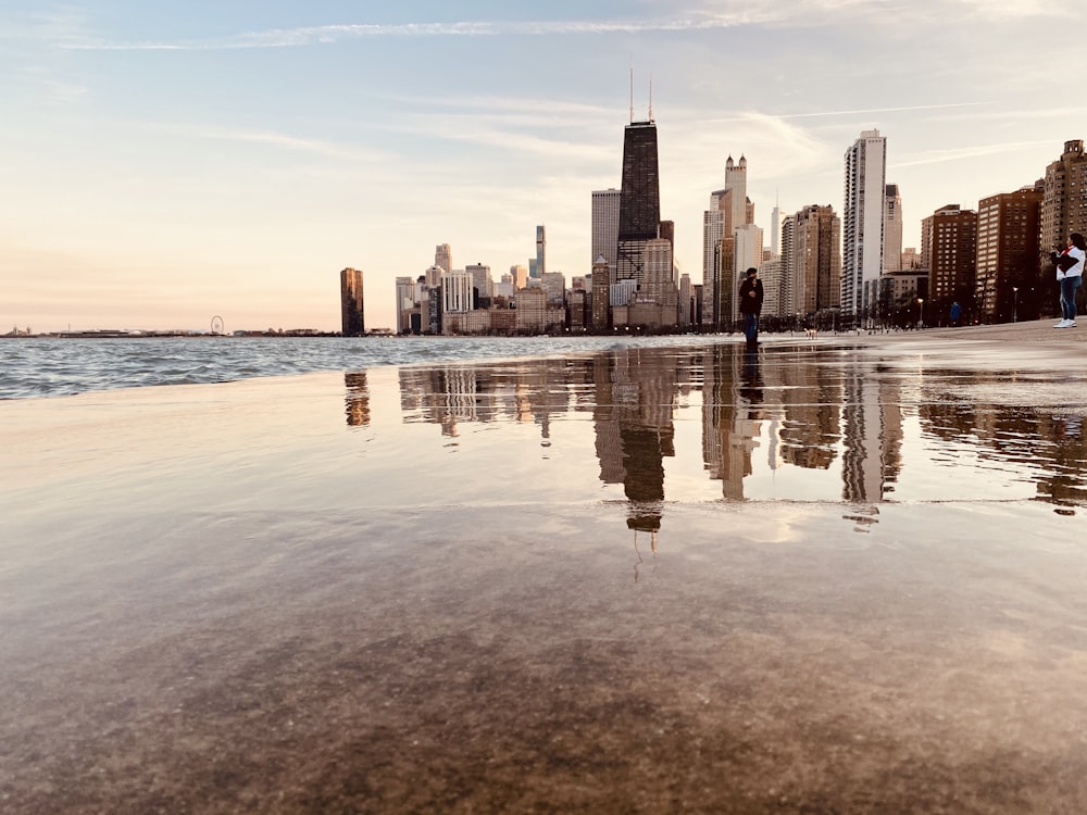 city skyline across body of water during daytime