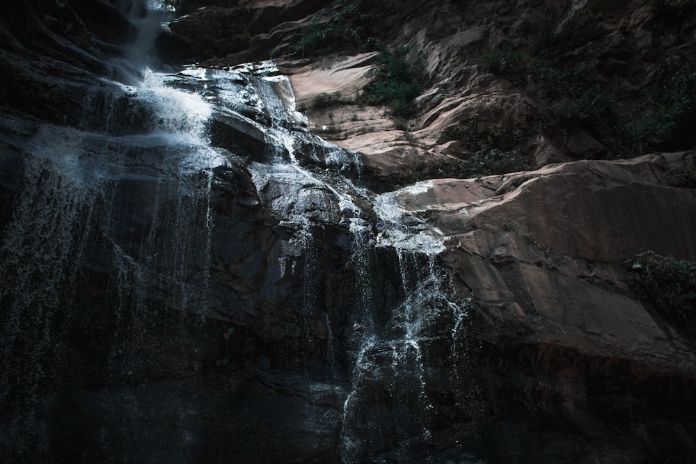 water falls on rocky mountain