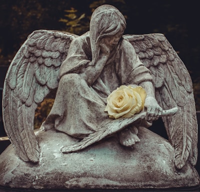man sitting on rock statue