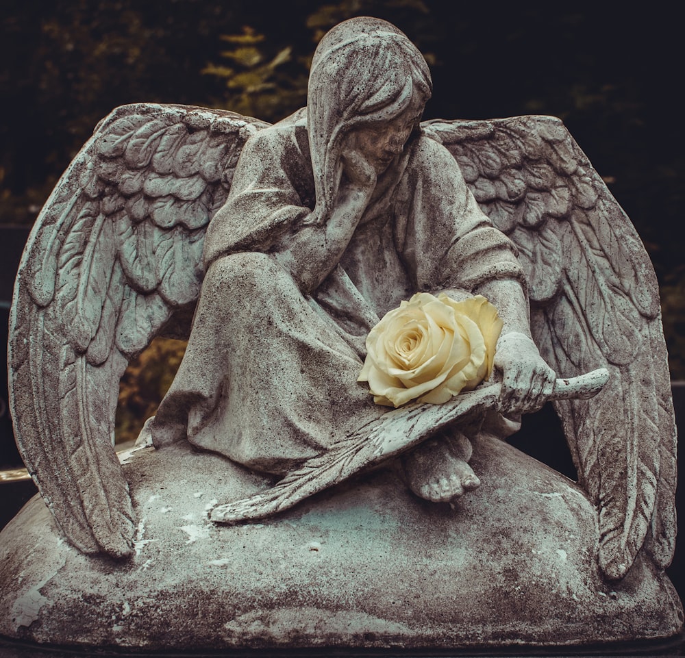 man sitting on rock statue