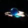 A close-up of a futuristic robotic hand gently holding a glowing blue orb.