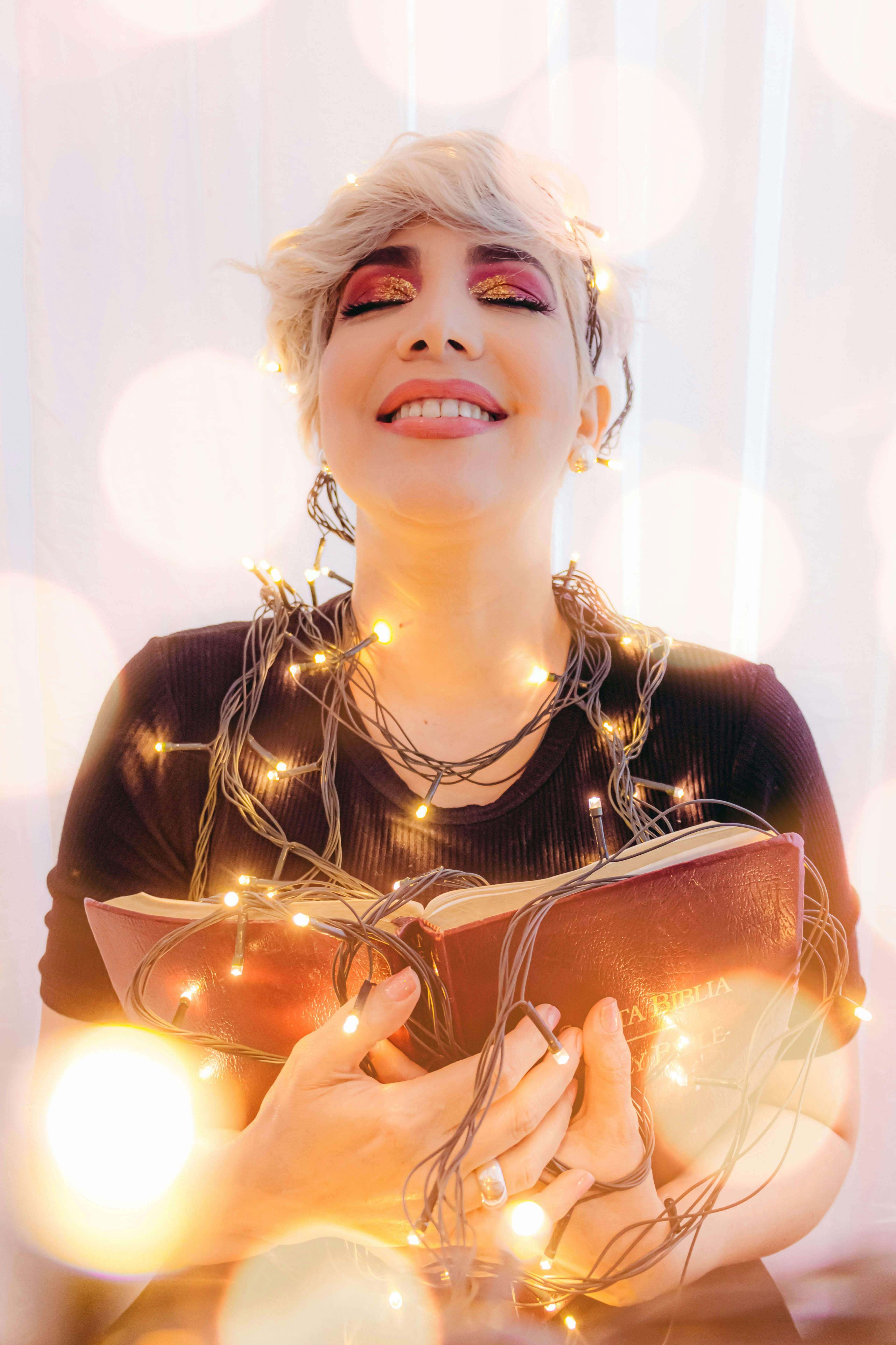 girl in black crew neck shirt holding brown leather pouch