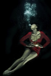 woman in red long sleeve shirt under water