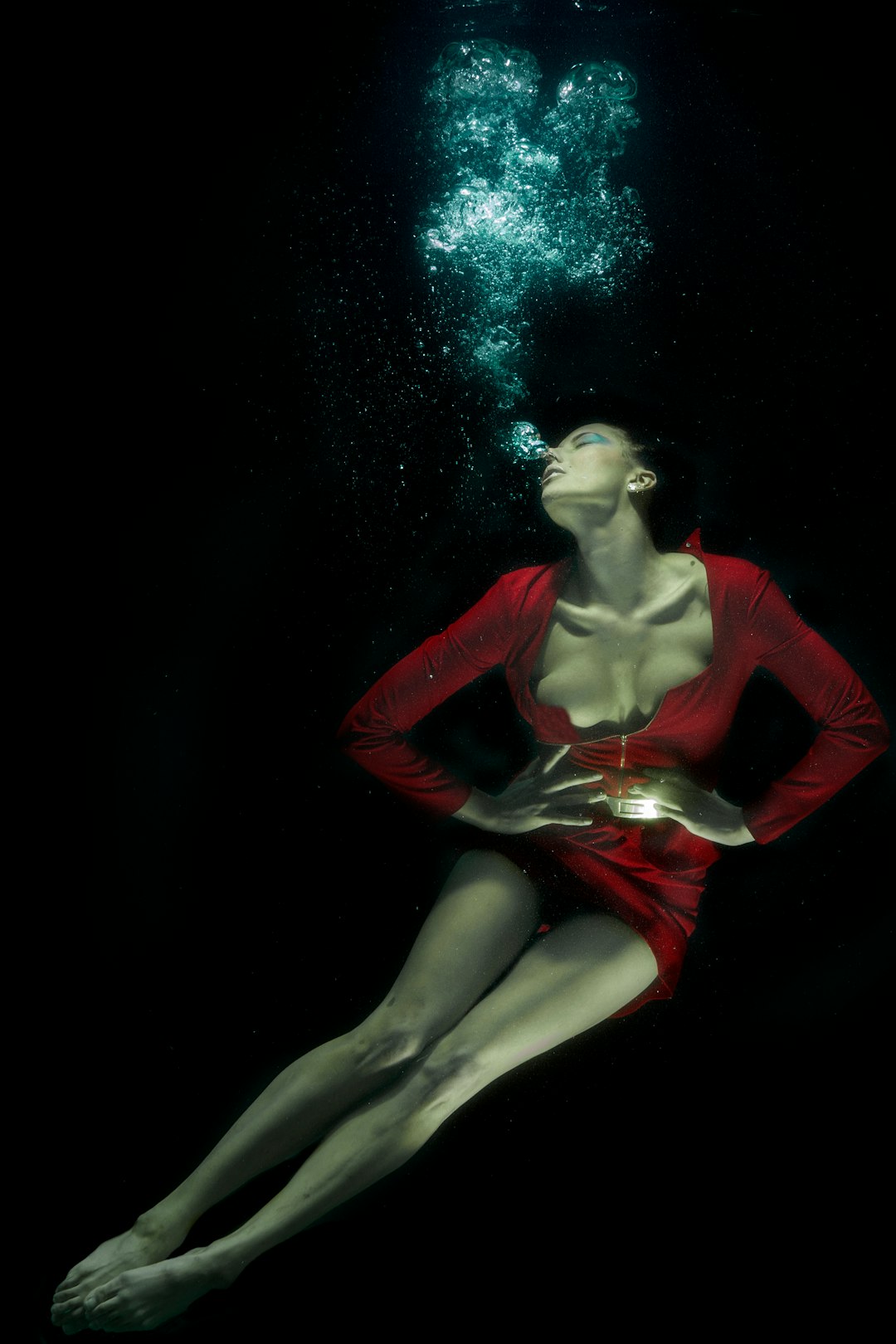 woman in red long sleeve shirt under water
