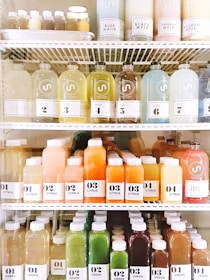 clear glass bottles on white metal rack