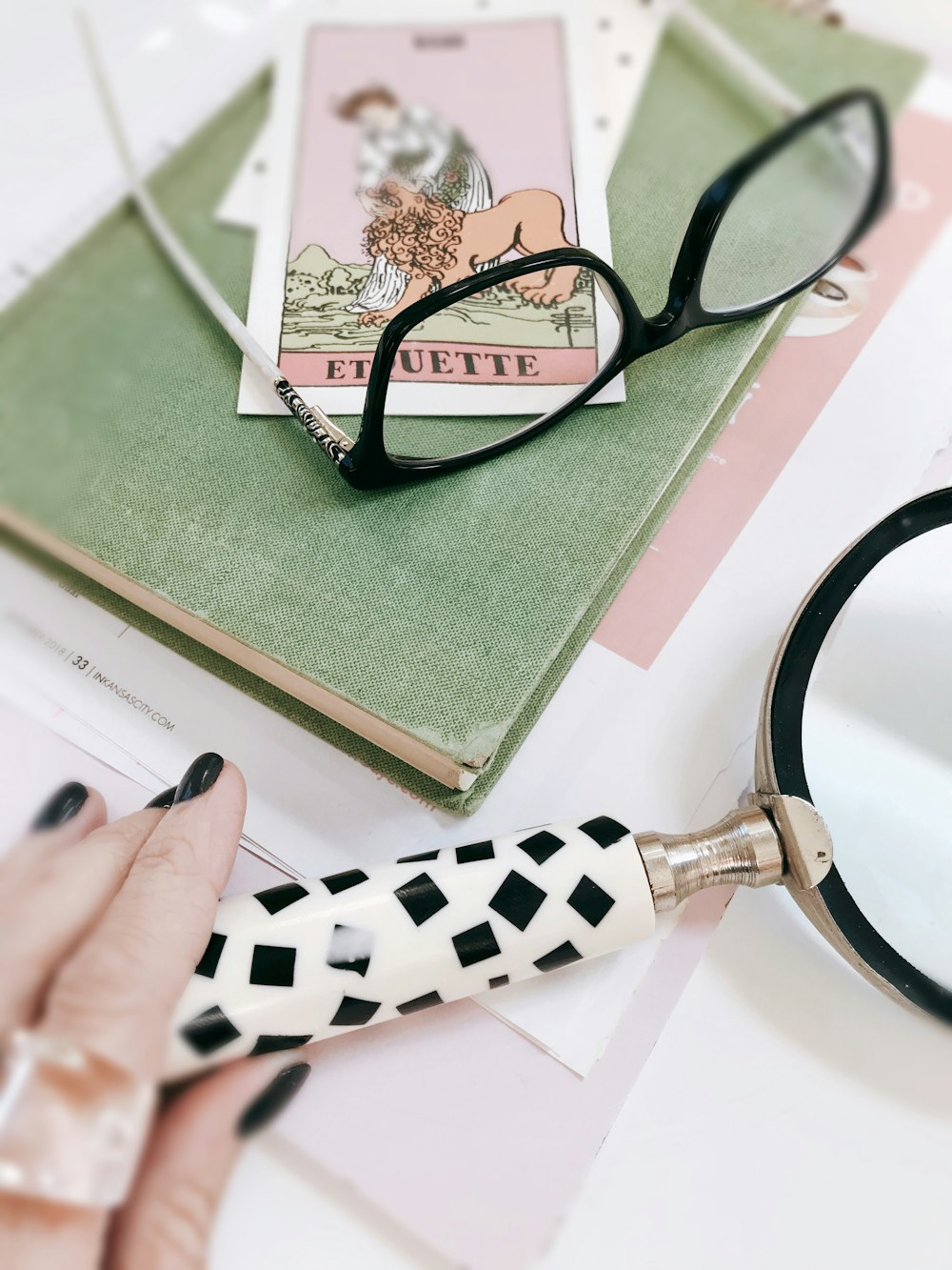 black framed eyeglasses on green table