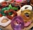 An artistic arrangement of rings with different colors and textures on a wooden surface.