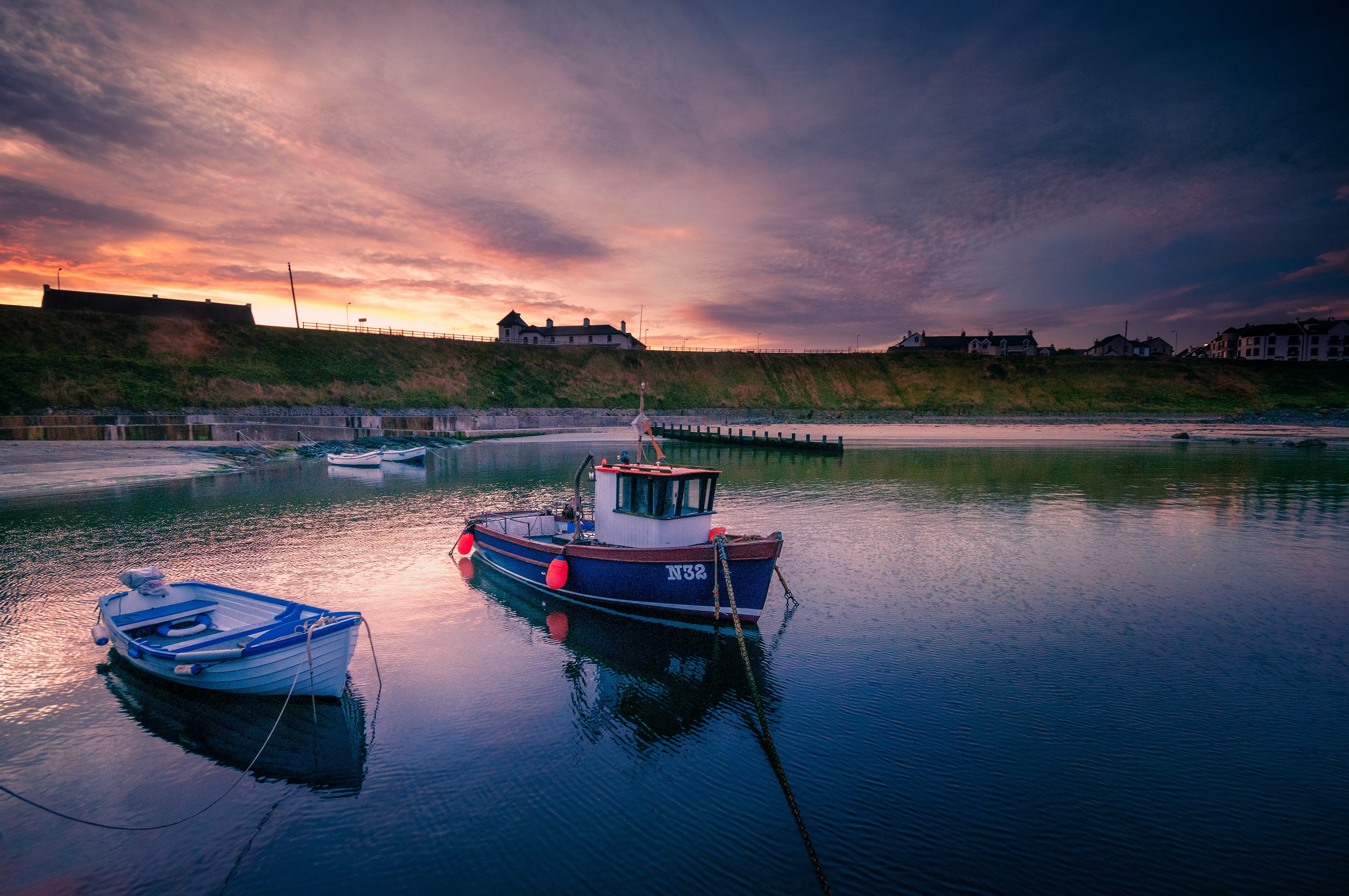 red and white boat on water during sunset