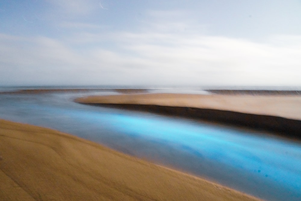 blue body of water under blue sky during daytime