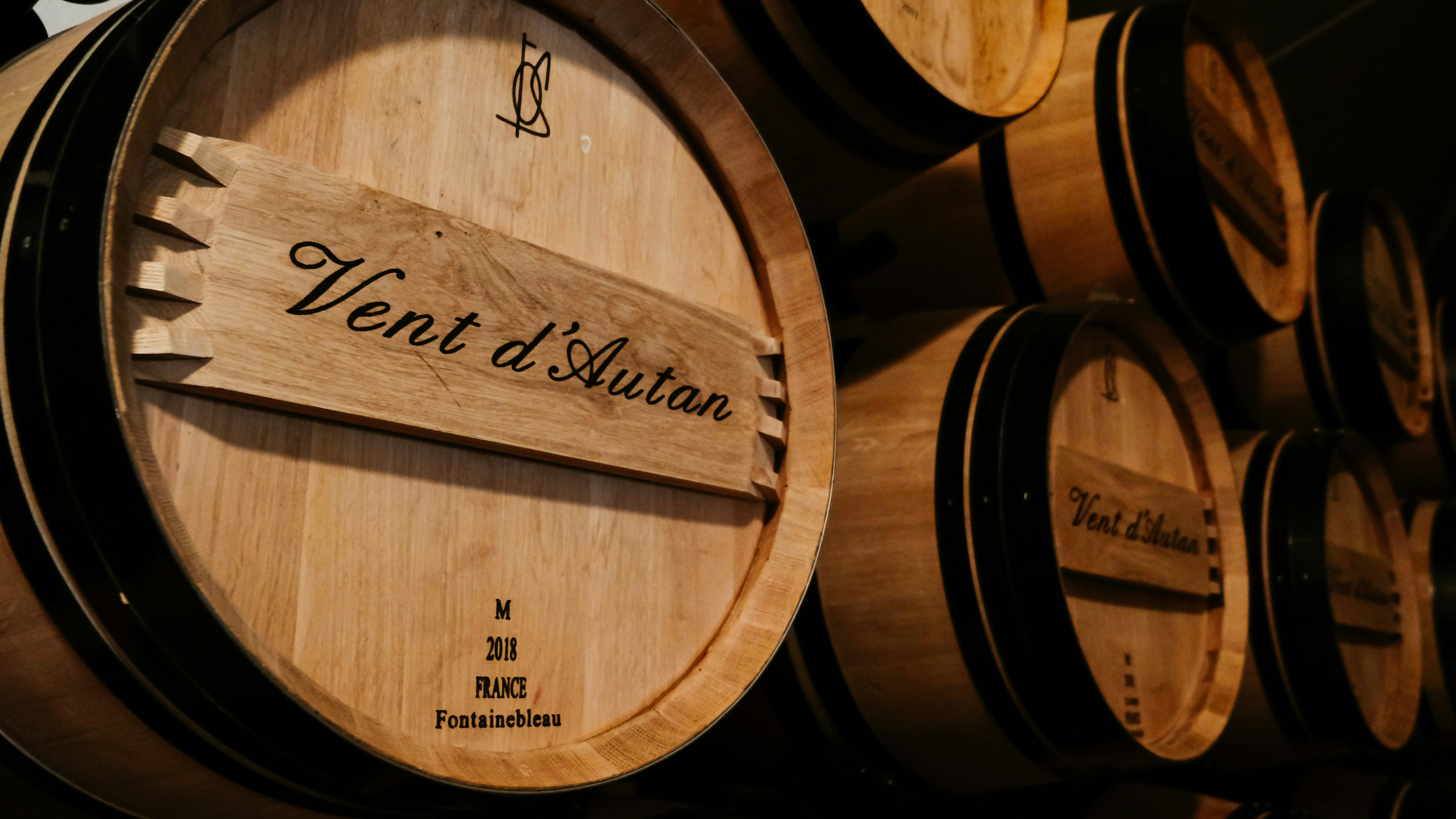 a bunch of wine barrels stacked on top of each other