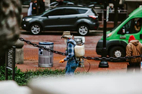 man in blue denim jeans and black jacket holding black metal basket