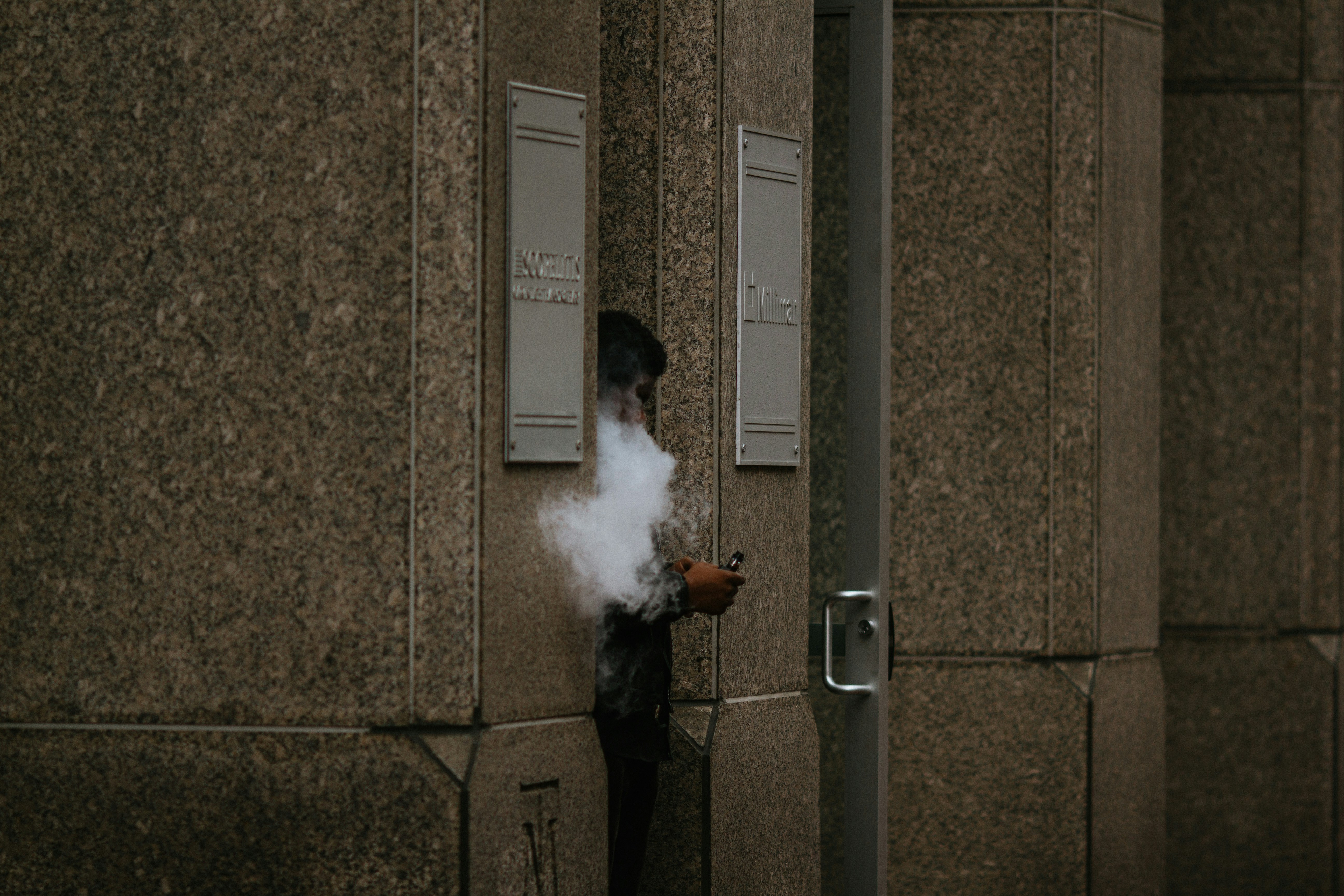 man in black jacket smoking