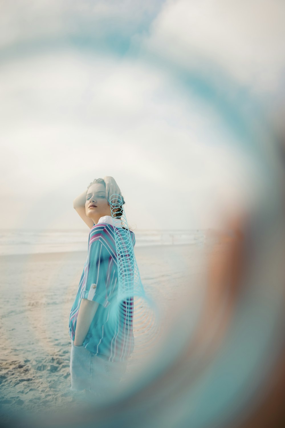 woman in blue and white dress standing on beach during daytime