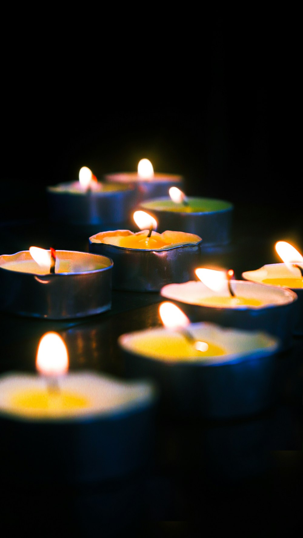 blue candles on black surface