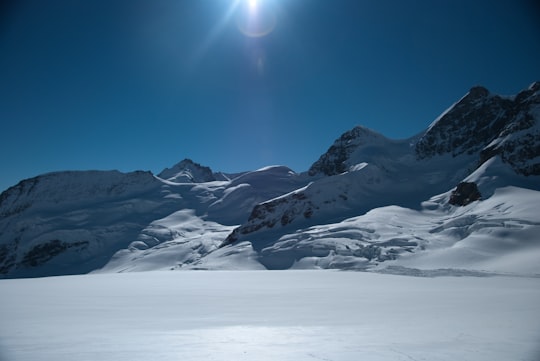 snow covered mountain under blue sky during daytime in Aletsch Glacier Switzerland