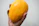 A happy customer holding a ripe mango with a bright kitchen background.