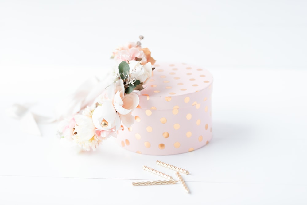 white and pink polka dot gift box with pink and white roses