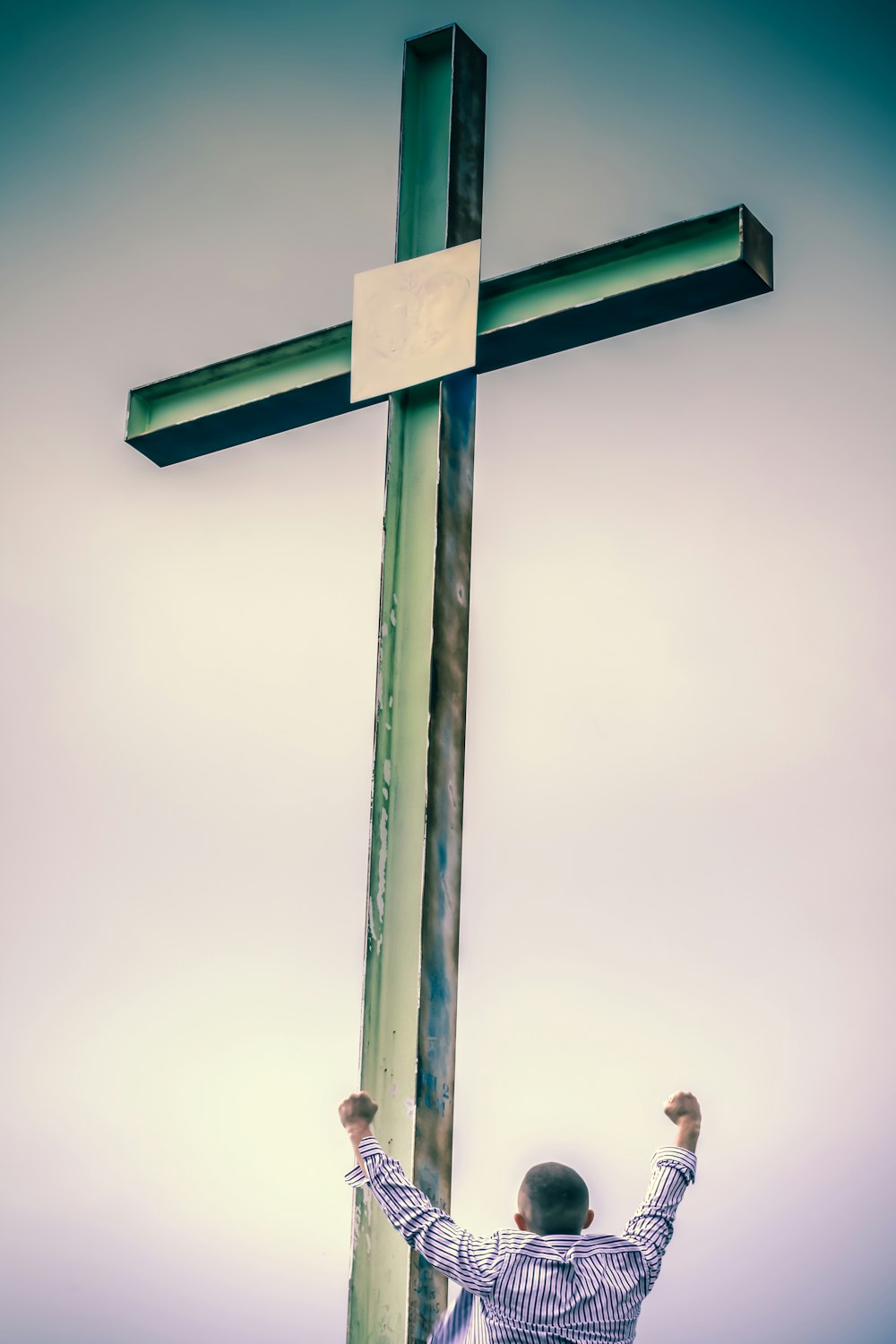 Premium Photo  Man standing in front of a cross with the words jesus on it