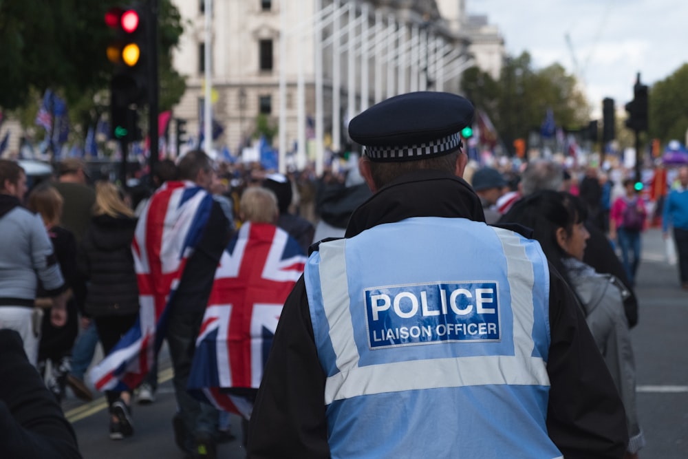 people in blue and white uniform standing on street during daytime