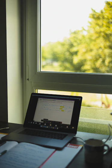 black laptop computer on green textile