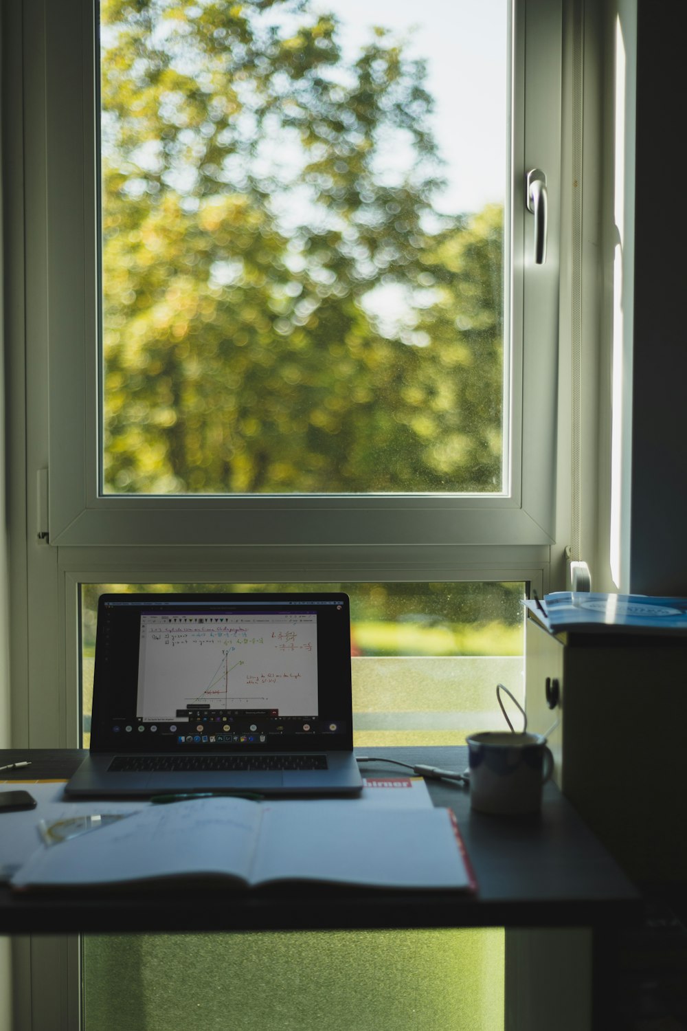 black laptop computer on brown wooden table