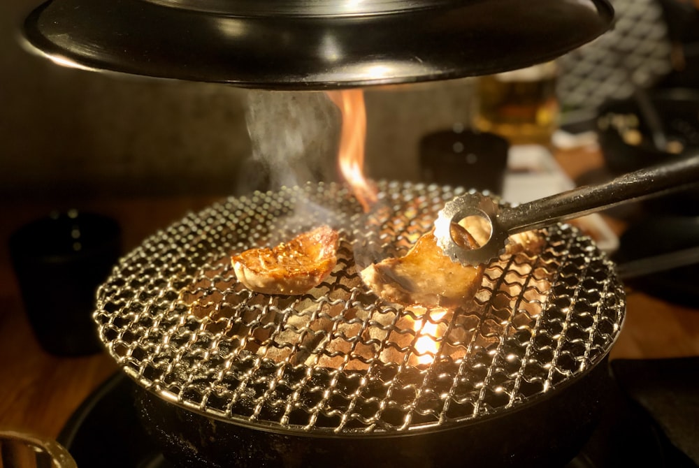 stainless steel spoon on top of black round pan