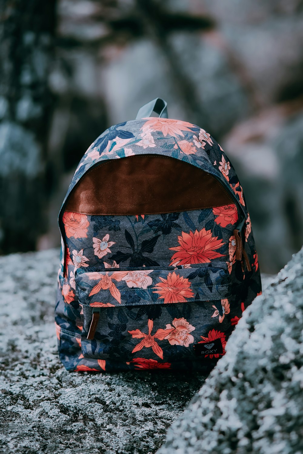 a backpack sitting on top of a rock