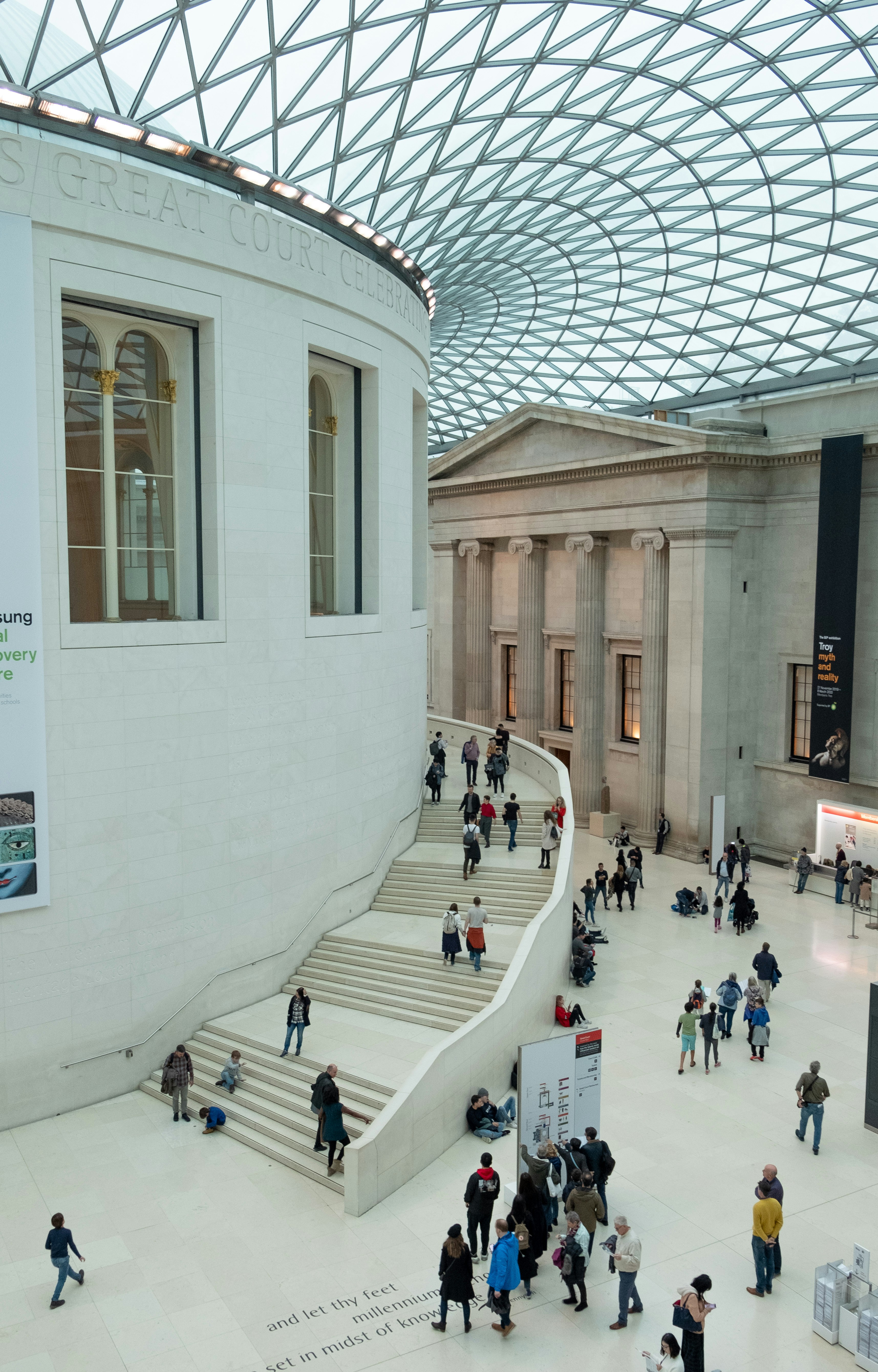 people walking on white concrete building during daytime