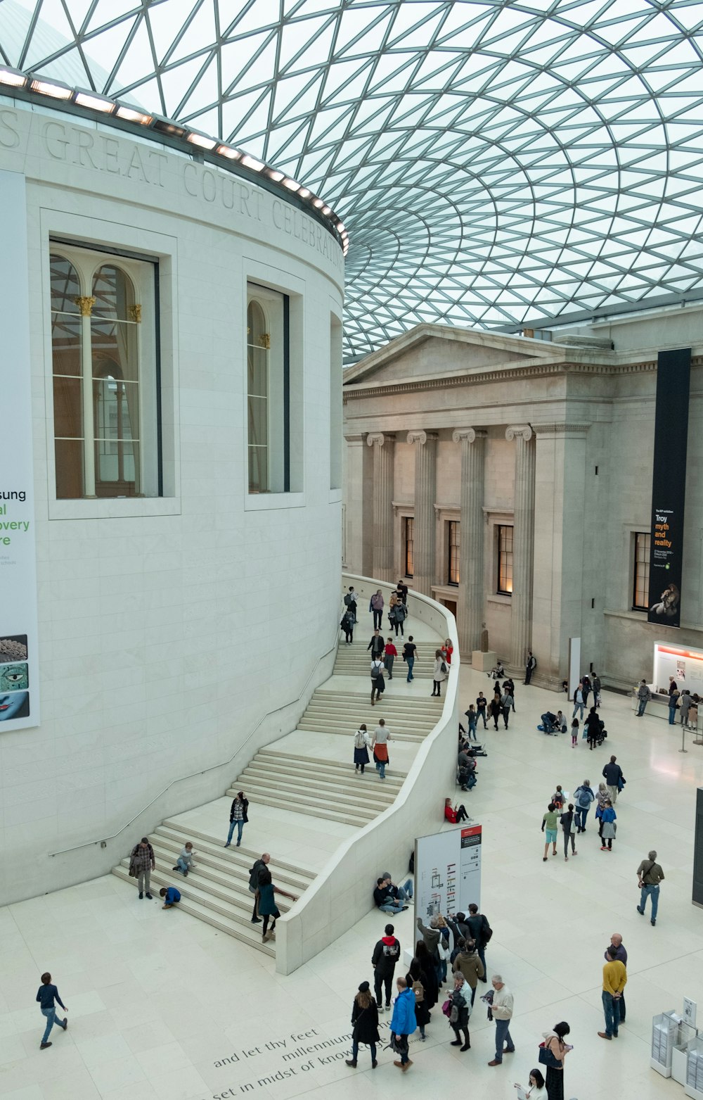 people walking on white concrete building during daytime