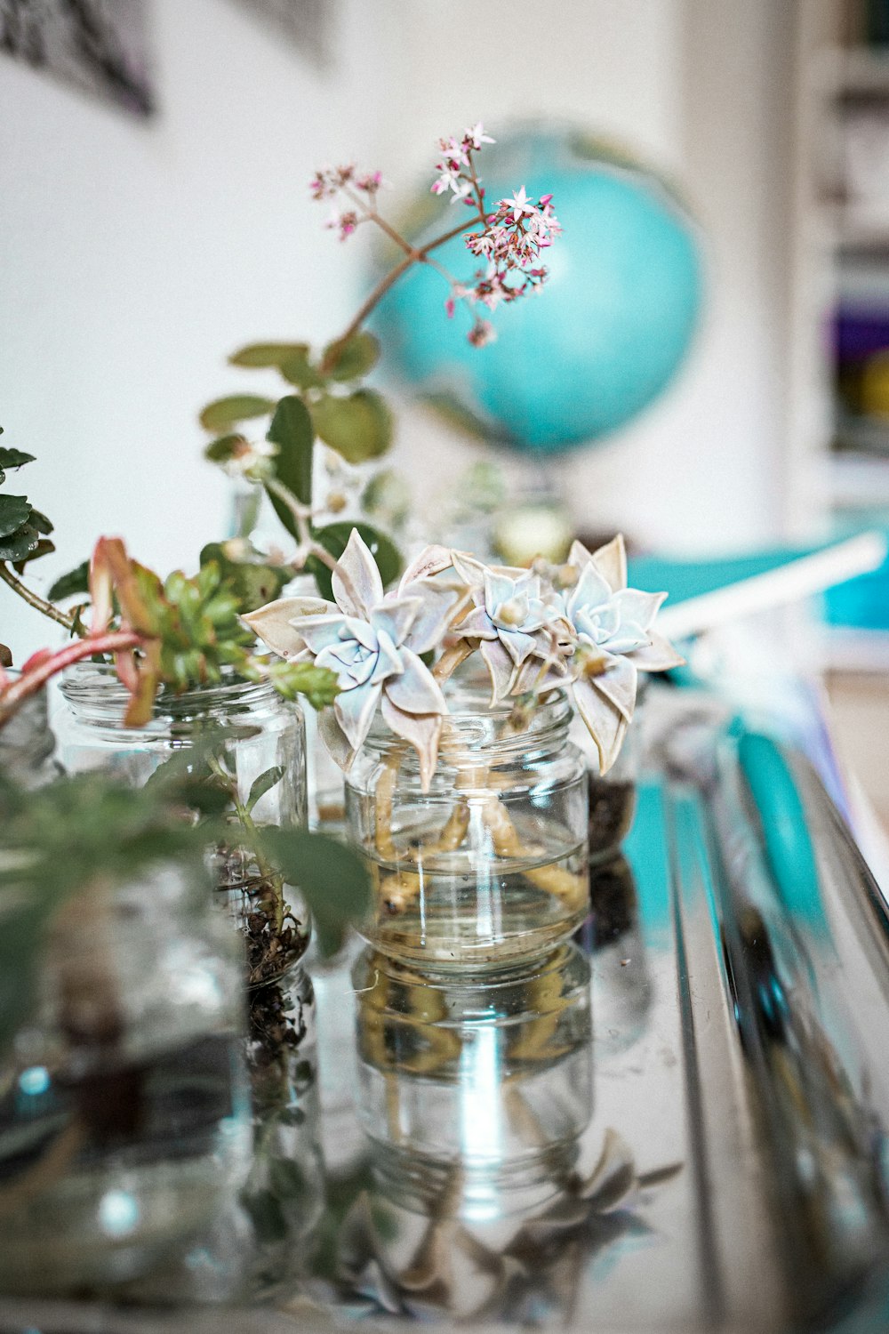 clear glass flower vase with blue and green balloons