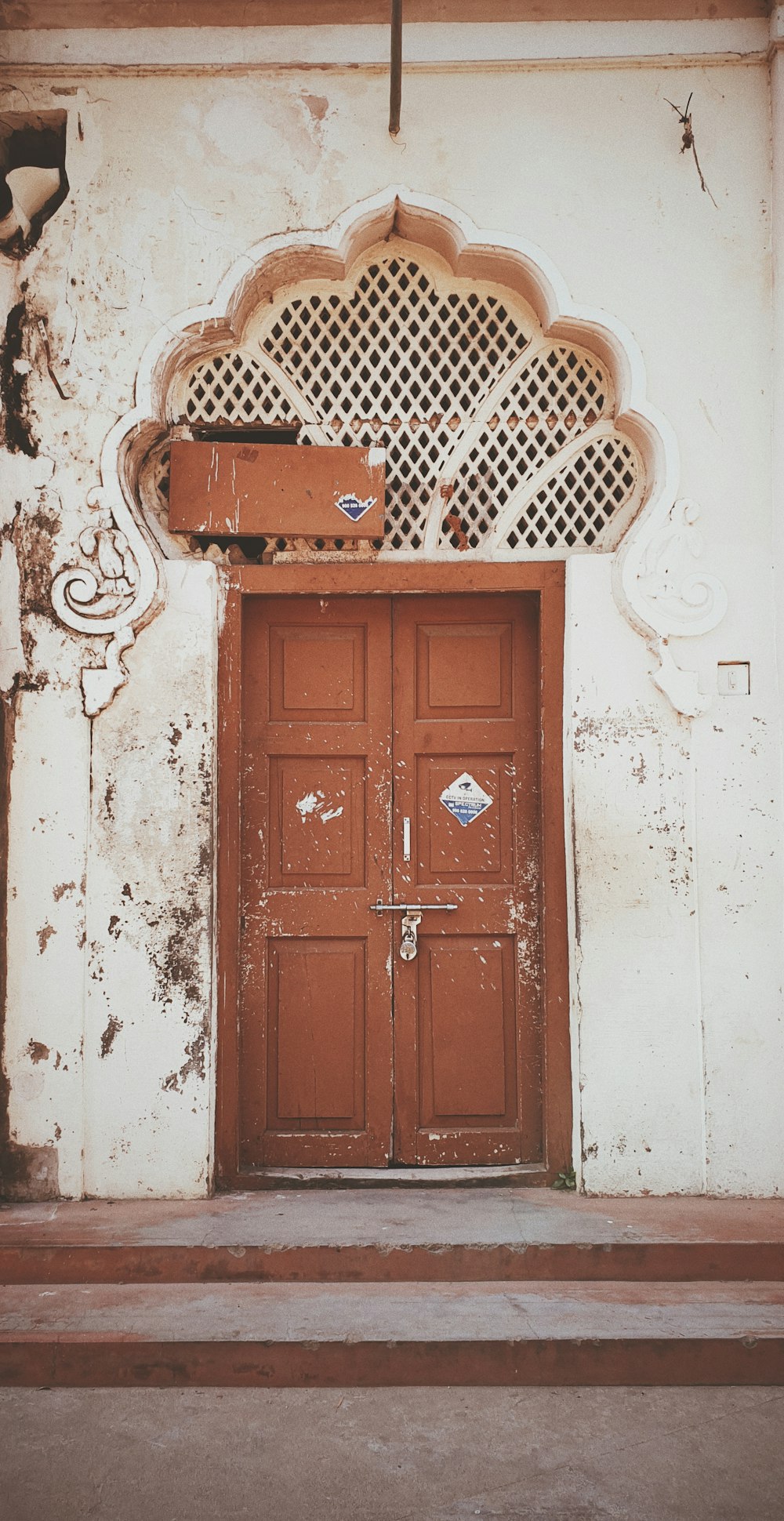 brown wooden door on white concrete wall